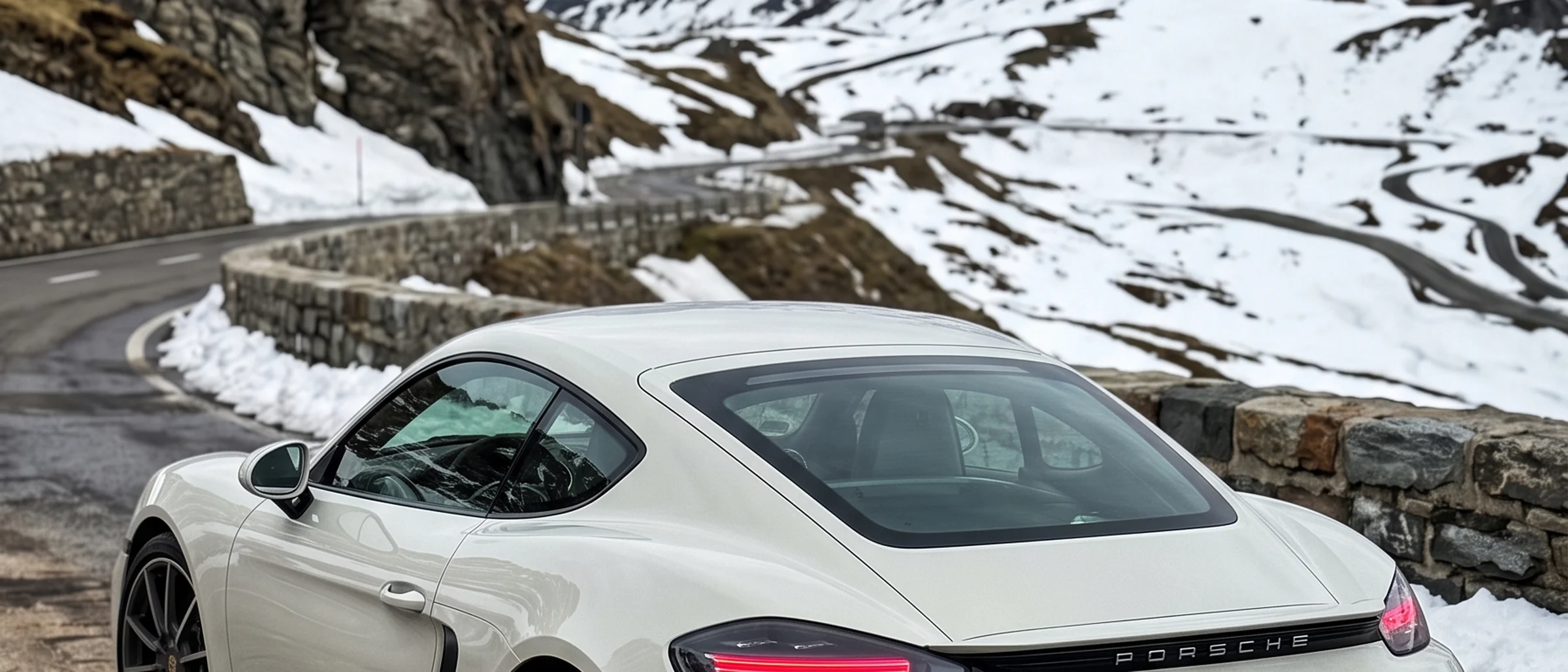 718 Cayman parked on a snow-lined mountain pass