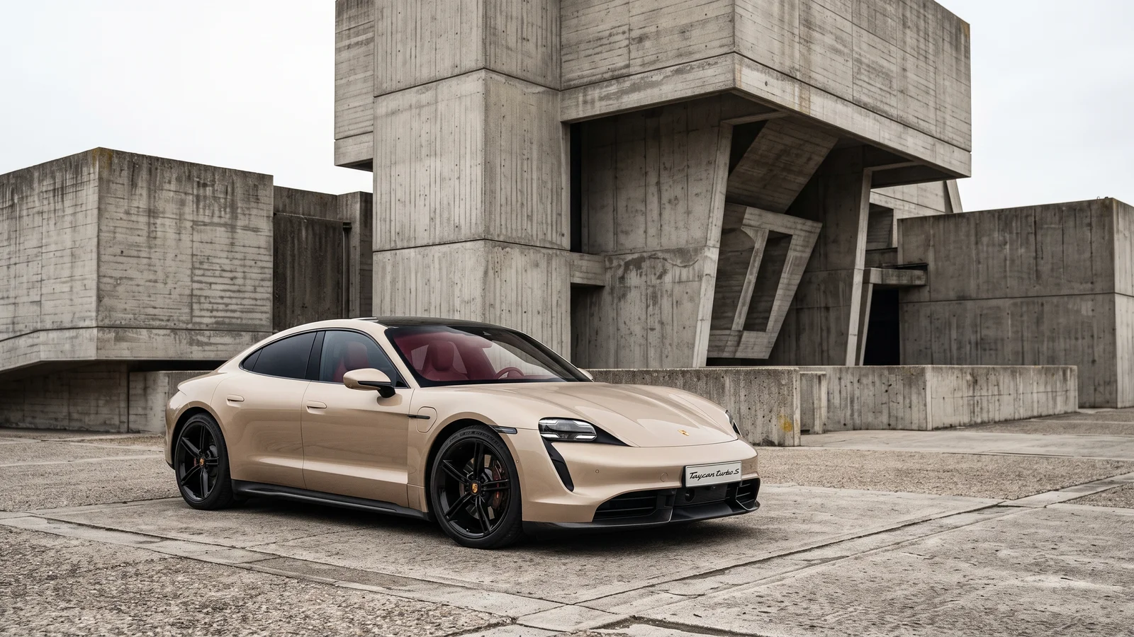 Taycan parked in front of a modern concrete building