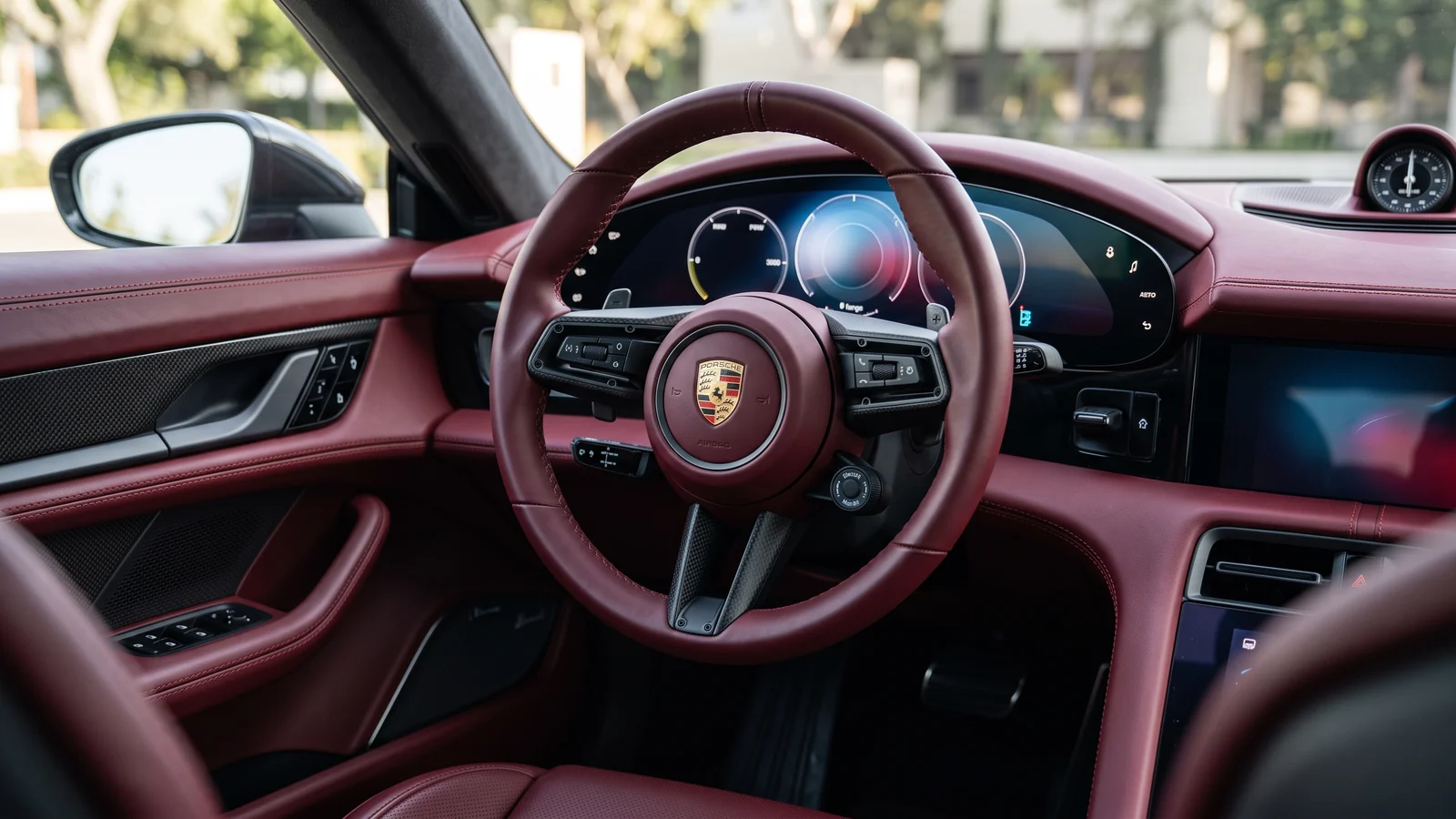 Deep Bordeaux red interior of the Taycan with curved display